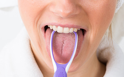 Close-up of someone brushing tongue