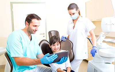 Dental office with staff and patient