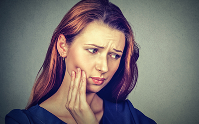 Woman with dry socket tooth pain