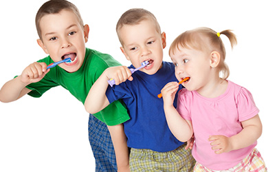 3 Kids brushing teeth