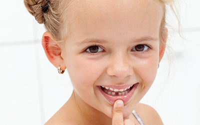 Little girl with missing tooth