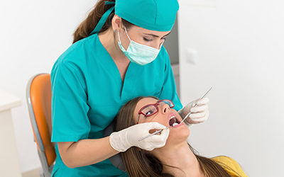 Young woman at the dentist having a procedure done