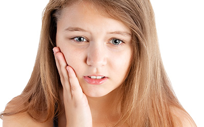 Young girl with tooth pain