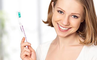 Woman holding a toothbrush